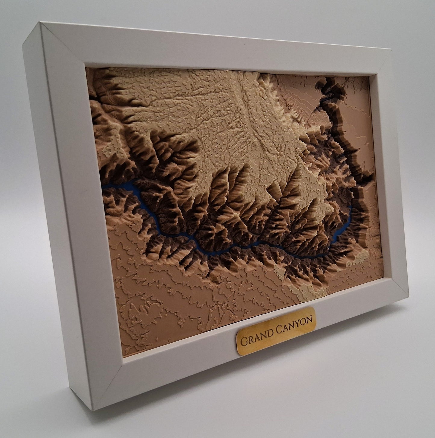Framed topographic map of the Grand Canyon on a white background