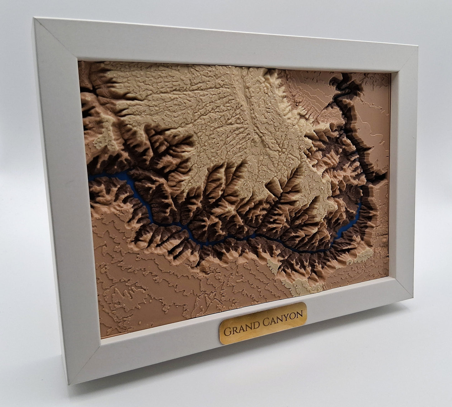 Framed topographic map of the Grand Canyon on a white background
