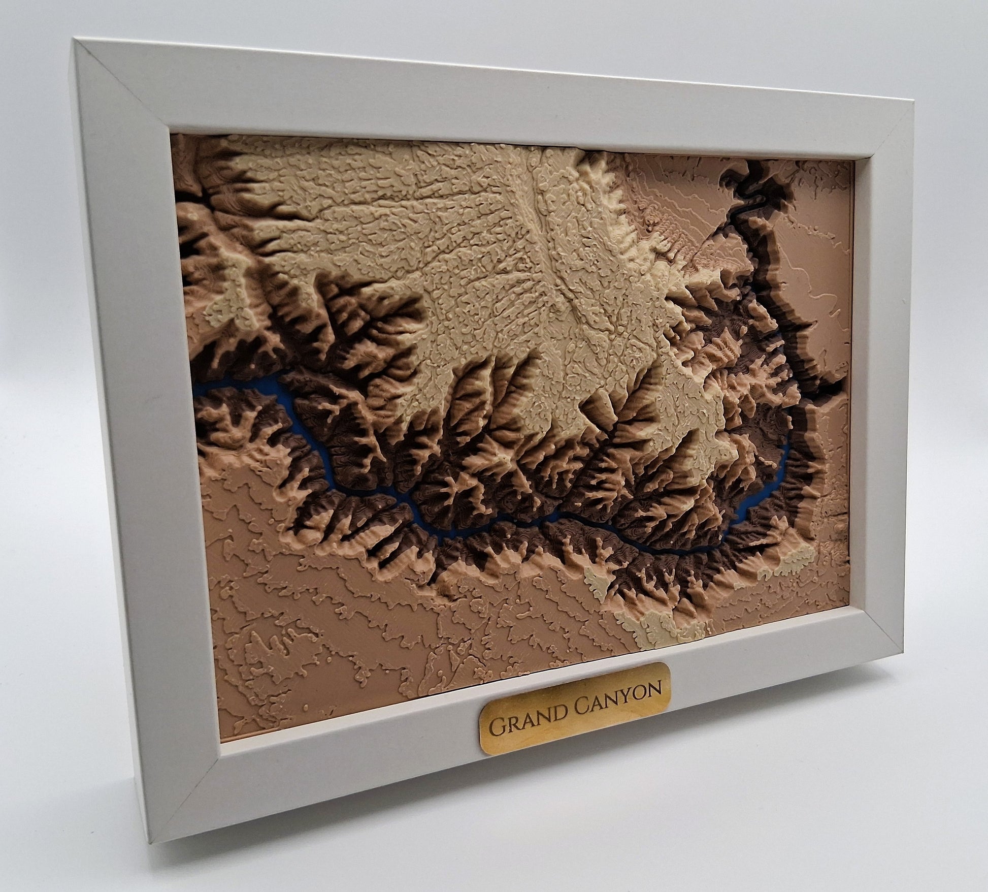 Framed topographic map of the Grand Canyon on a white background
