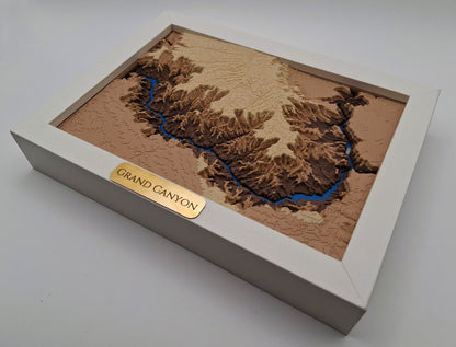 3D model of the Grand Canyon with a gold plaque on a white background