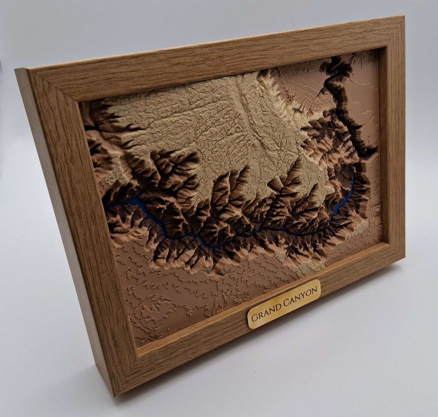 Wooden framed model of the Grand Canyon on a white background