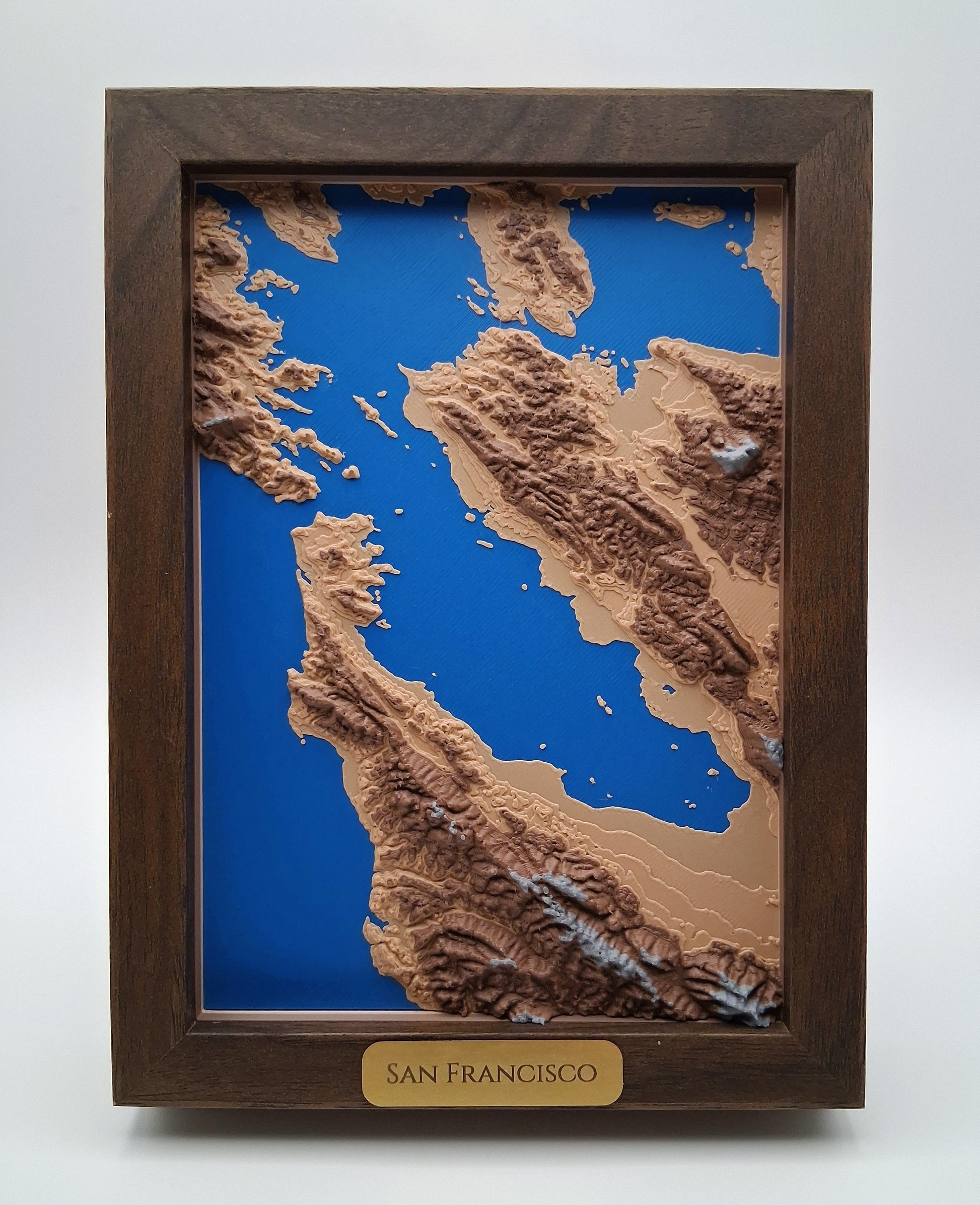 Topographic map of San Francisco in a wooden frame on a white background