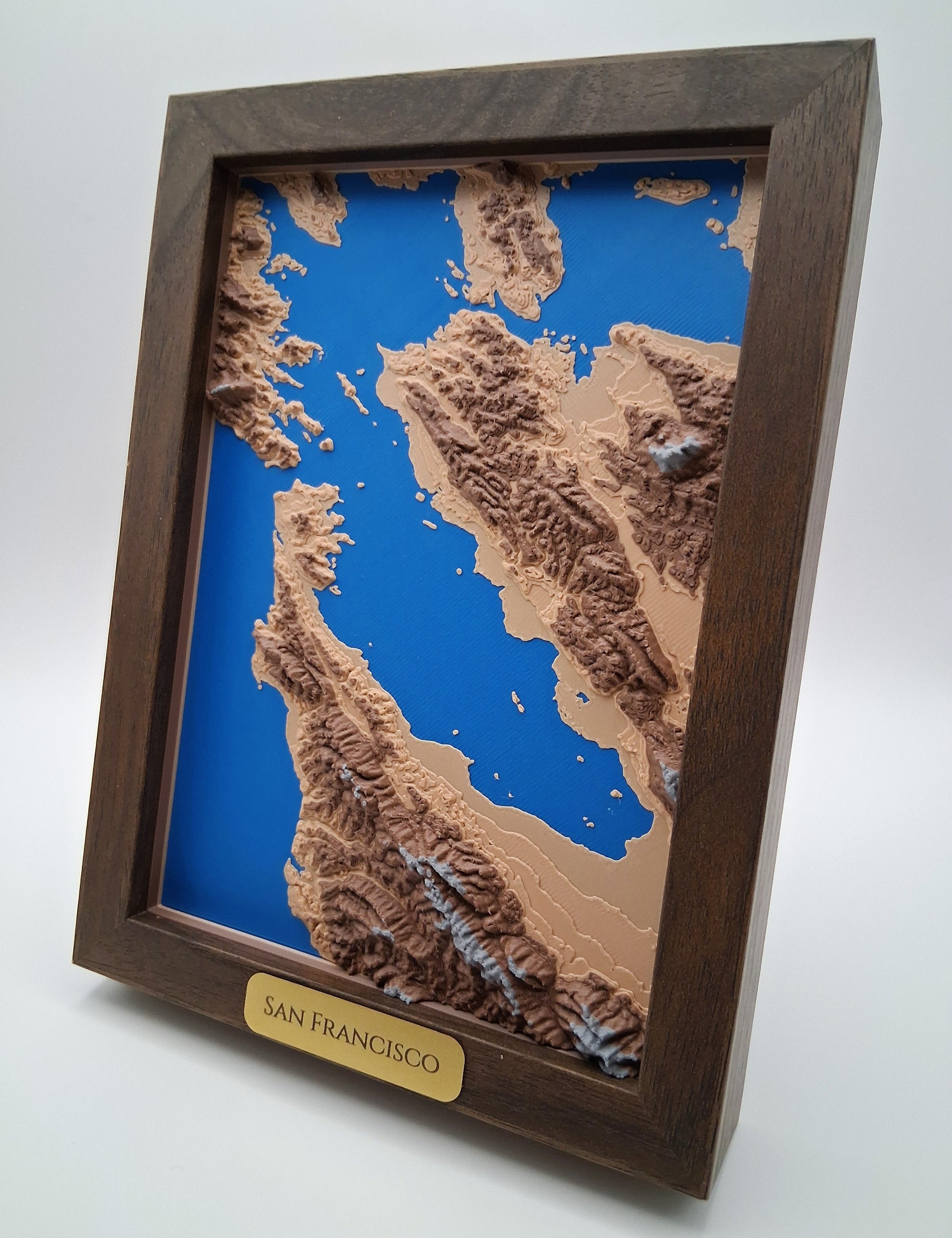 Framed topographic map of San Francisco with a wooden frame on a white background