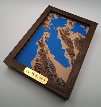 Topographic model of San Francisco in a wooden frame on a gray background