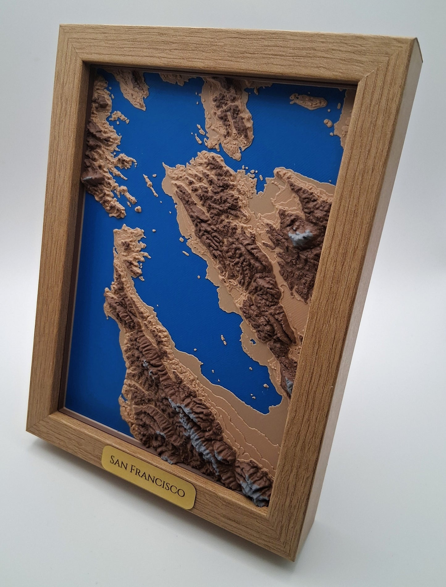 Topographic map of San Francisco in a wooden frame on a white background