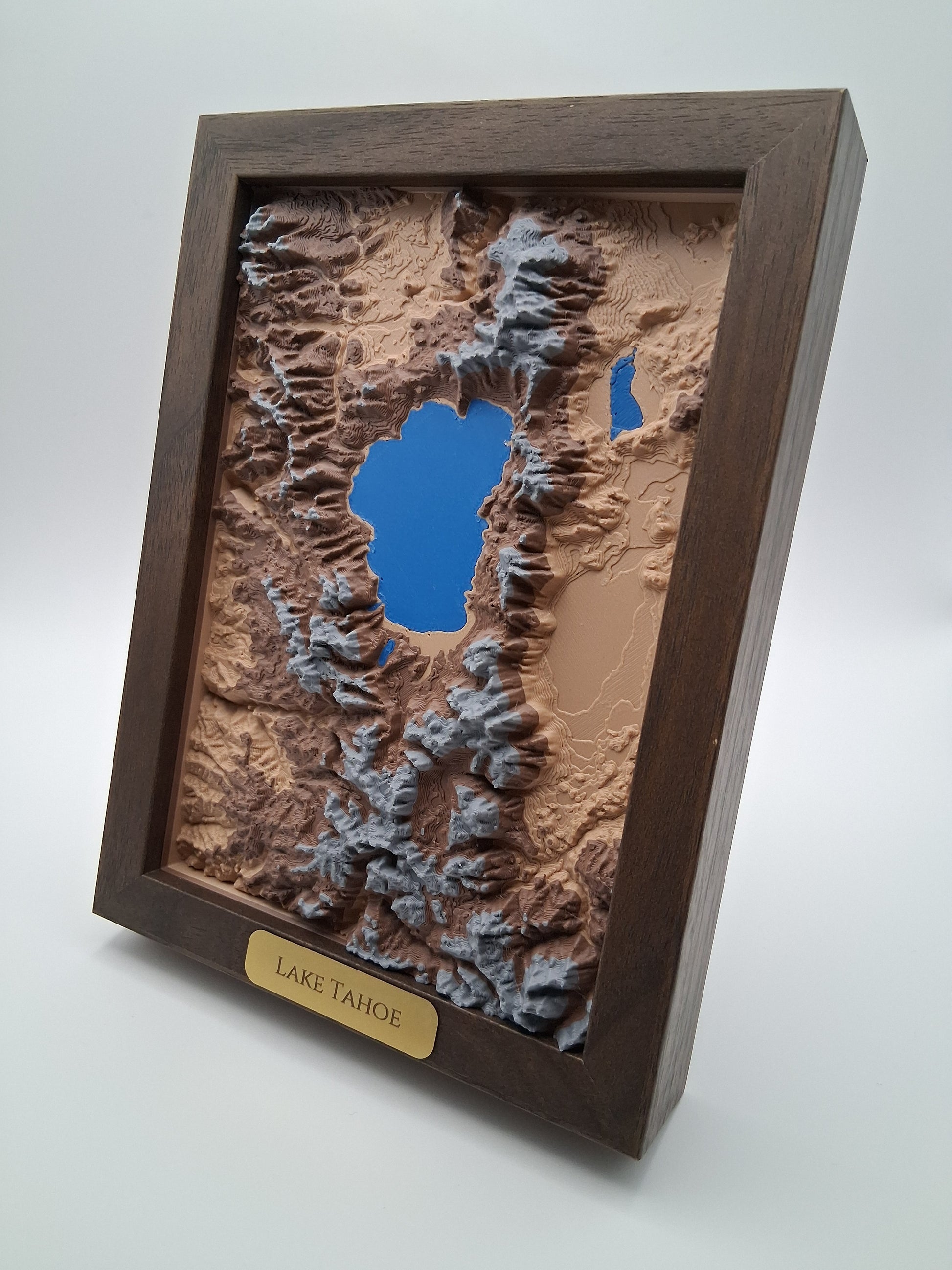 Topographic model of a lake with a wooden frame on a white background