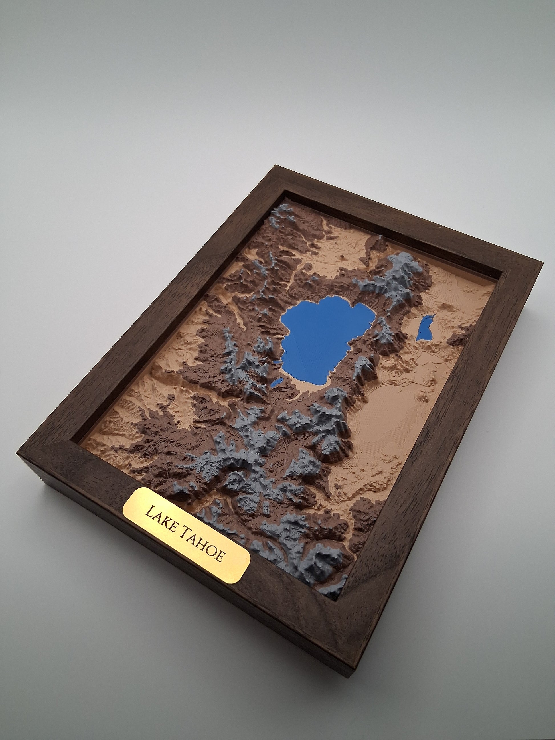 Topographic model of a lake with a wooden frame and 'Lake Tahoe' label.
