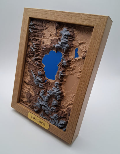 Topographic model of Lake Tahoe in a wooden frame on a white background