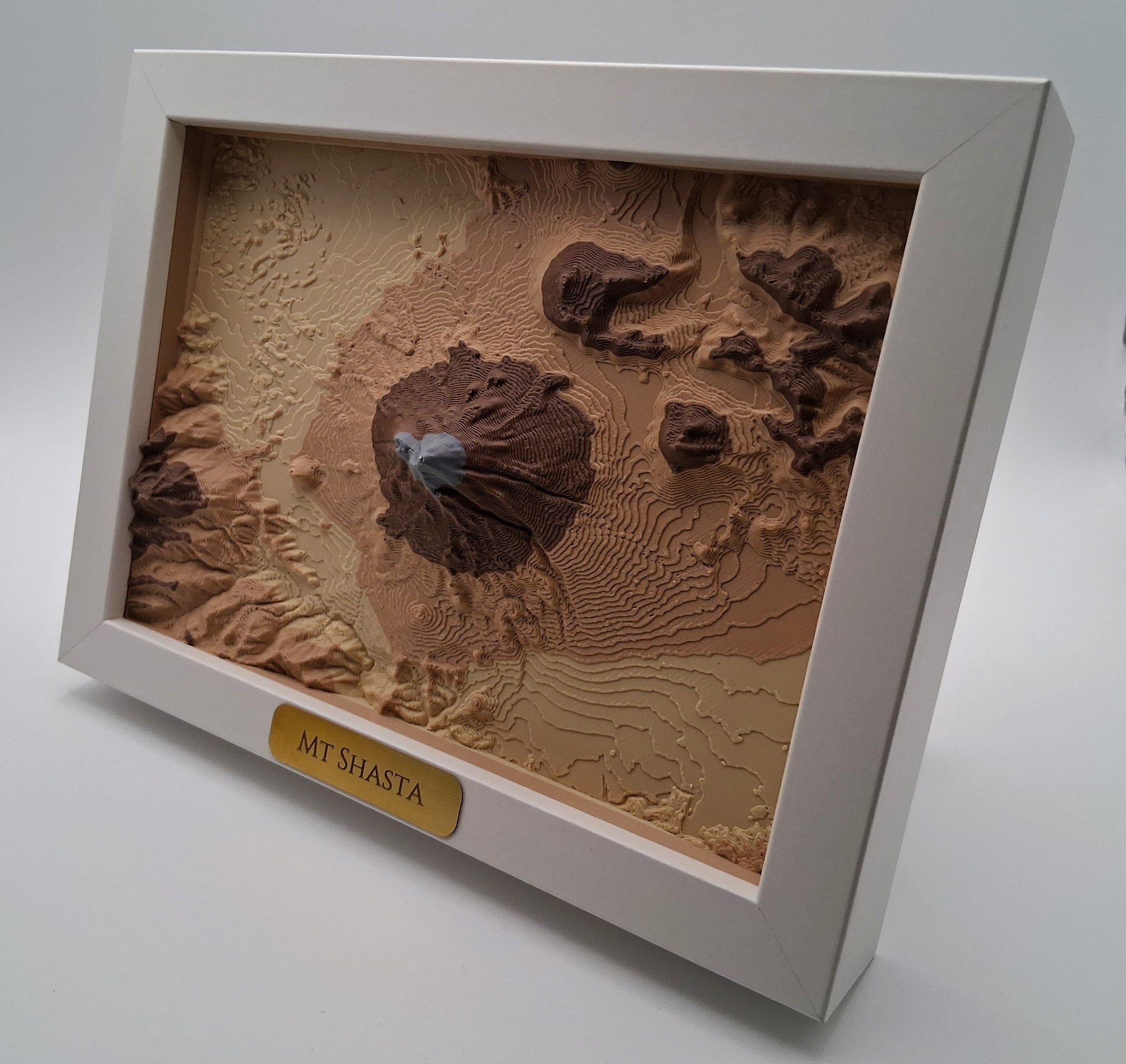 3D textured map of Mount Shasta in a white frame on a gray background