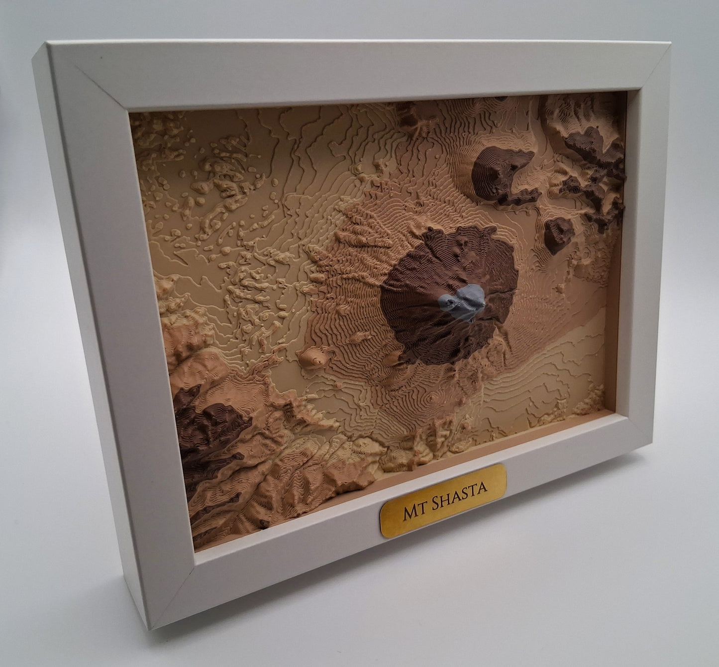 3D topographic map of Mount Shasta in a white frame on a light gray background