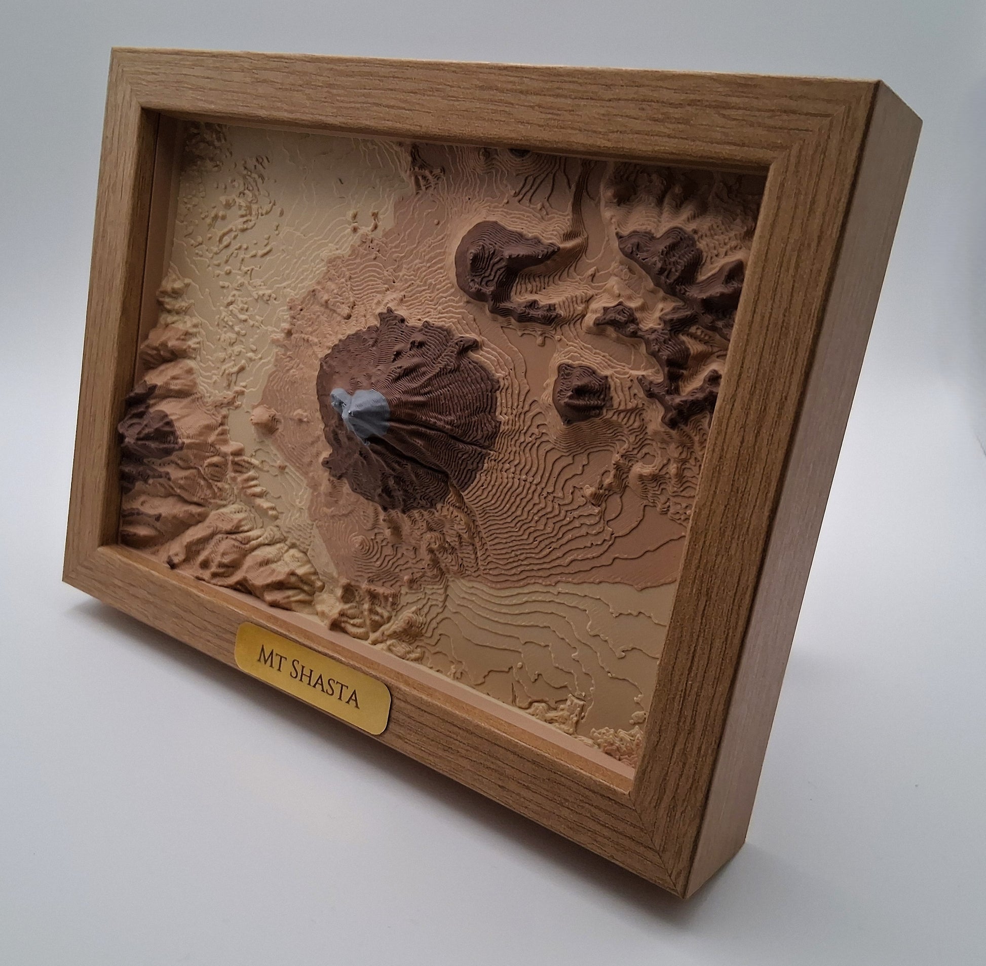 3D model of Mount Shasta in a wooden frame on a white background
