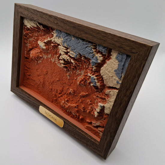 Video of a 3D topgraphic map of sedona, arizona in a wooden frame slowly rotating.