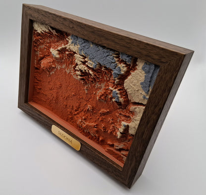 Video of a 3D topgraphic map of sedona, arizona in a wooden frame slowly rotating.