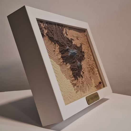 Video of a 3d topographic print of mount wrightson and madera canyon in a white frame slowly spinning.