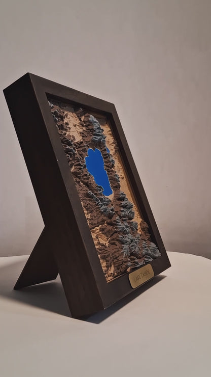 Topographic model of Lake Tahoe in a walnut frame on a light gray background