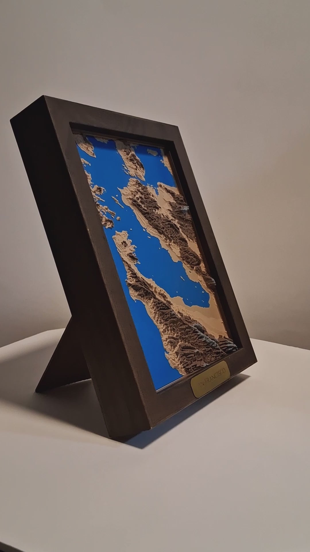 Wooden framed topographic map of San Francisco Bay with a white background